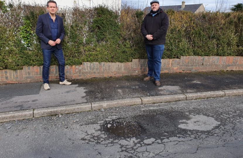 Mark Jenkinson and Councillor Colin Sharpe with pothole