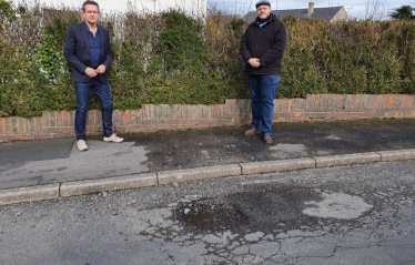 Mark Jenkinson and Councillor Colin Sharpe with pothole